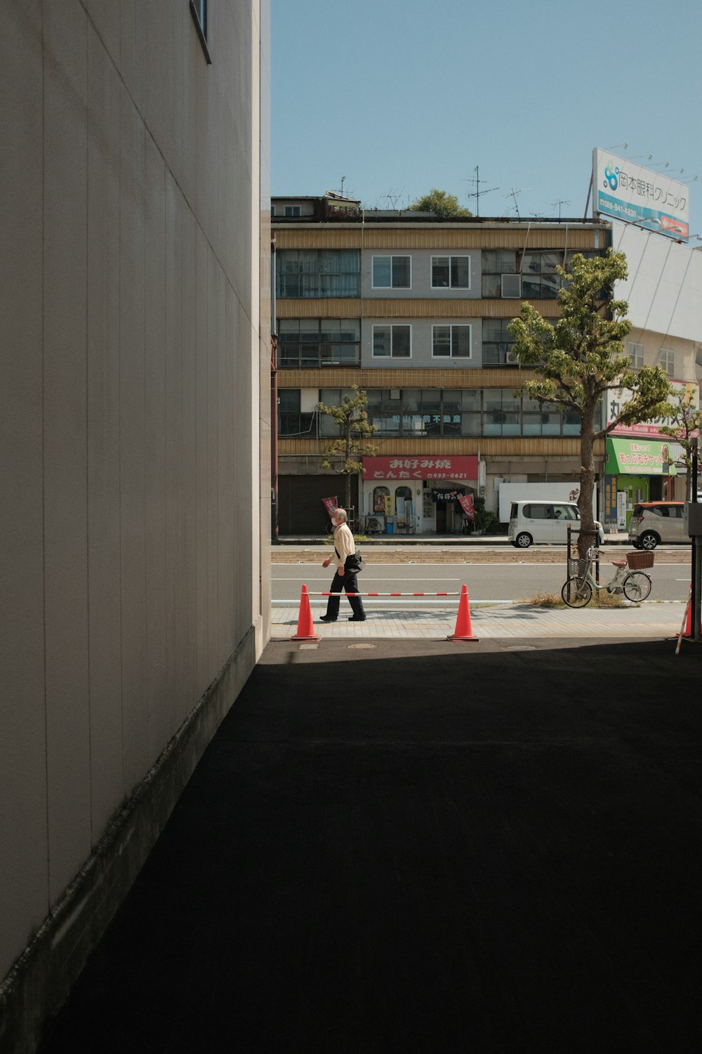 woman in red dress walking on sidewalk during daytime