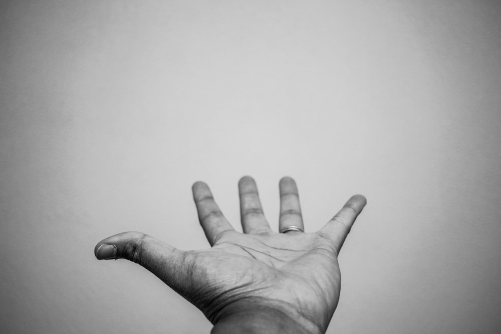 grayscale photo of persons left hand