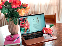 A MacBook mockup displaying a prompt pack PDF with violet accent highlights on a clean white background.