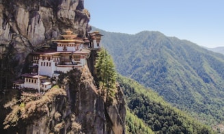 white and brown concrete building on top of mountain during daytime