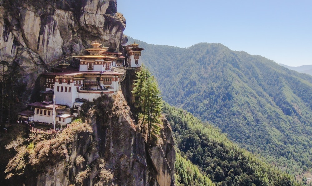 white and brown concrete building on top of mountain during daytime