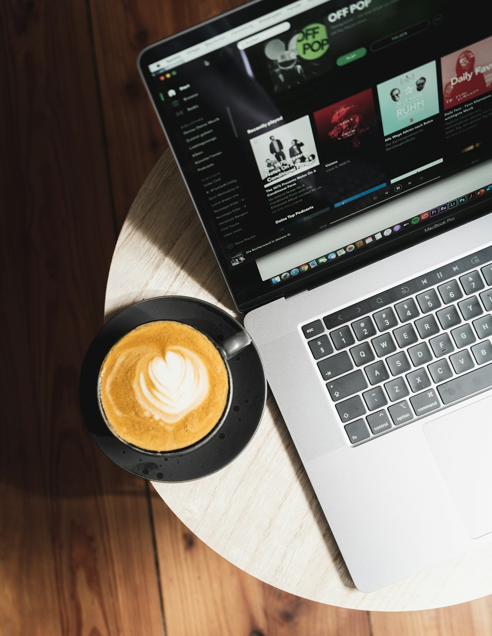 macbook pro on brown wooden table