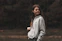 woman in gray zip up jacket standing on brown field during daytime