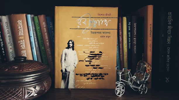 Portrait of Atmaram Gangaram surrounded by shelves filled with rare books.