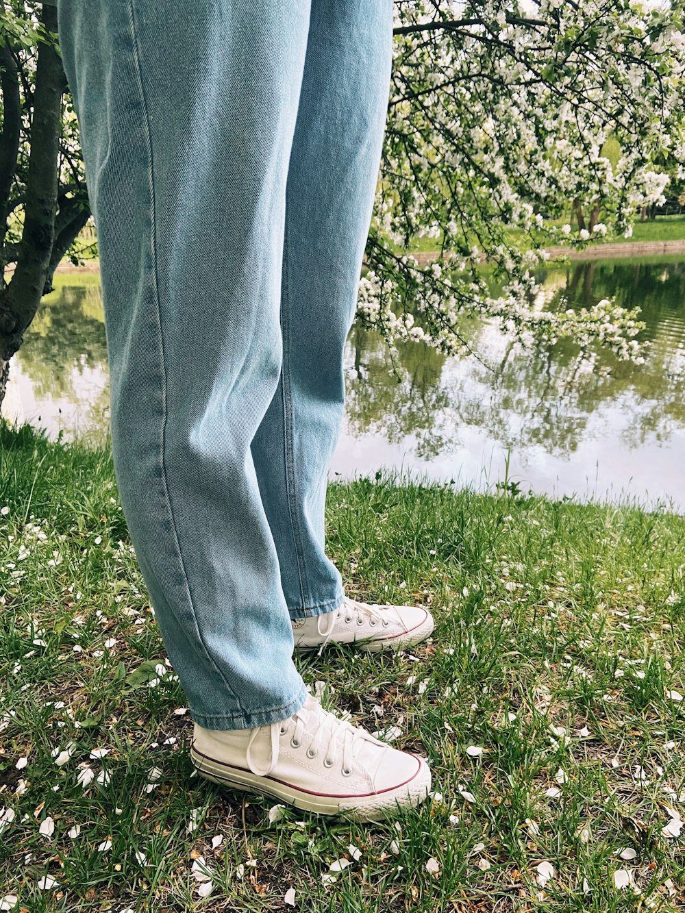 person in blue denim jeans and brown lace up shoes