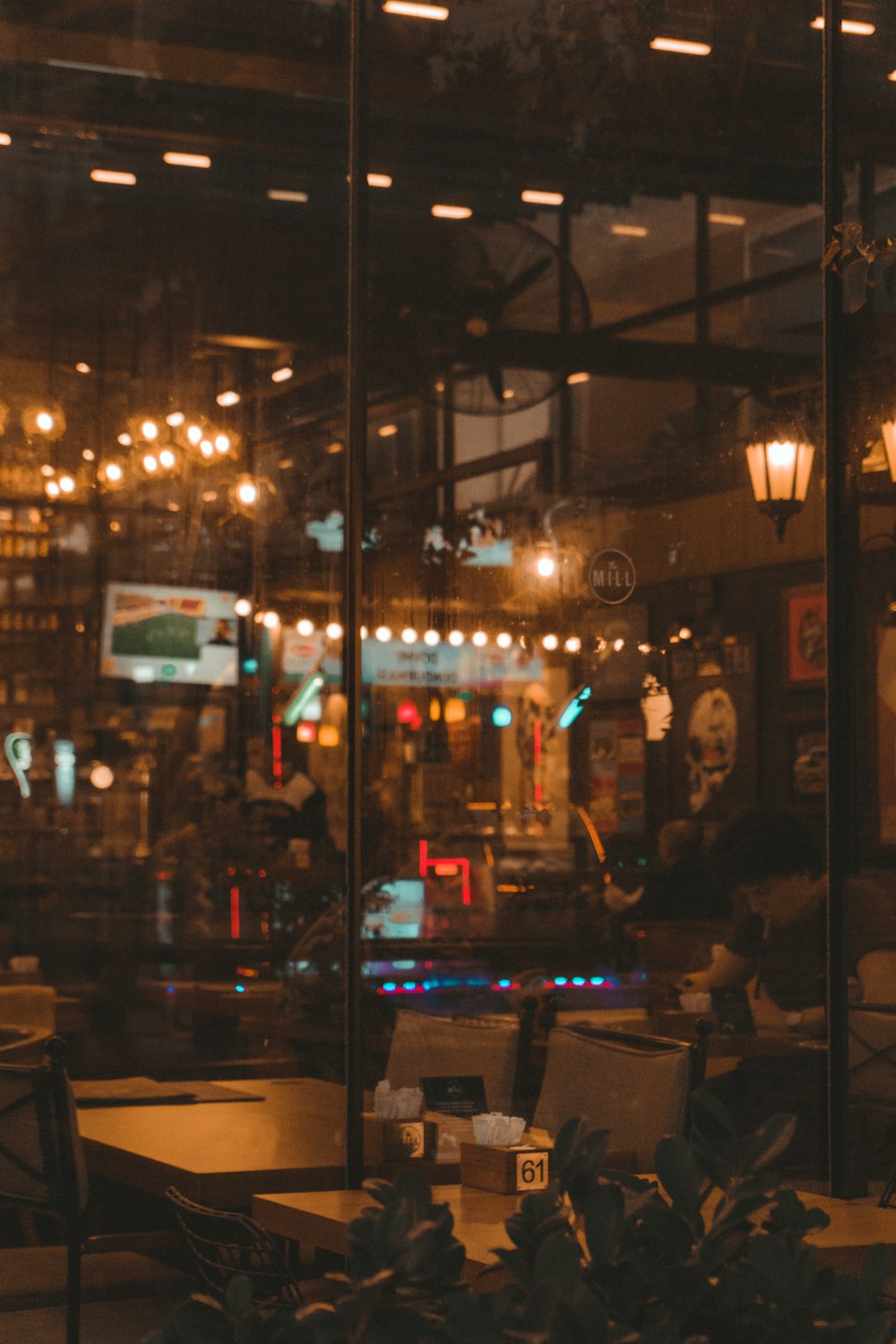 people sitting on chair near store during night time