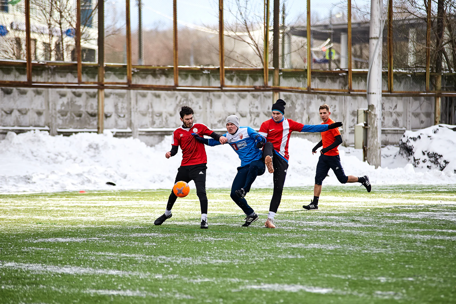 Young soccer players running on an outdoor field during a sports game
