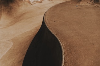 brown wooden round table on brown sand