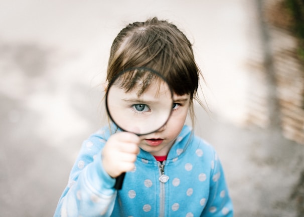 girl in blue and white polka dot jacket