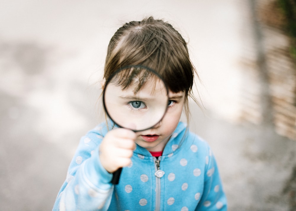 girl in blue and white polka dot jacket