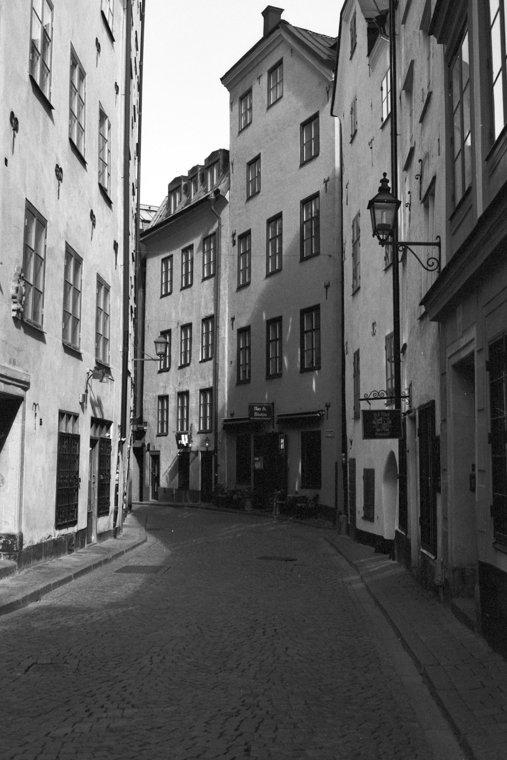 grayscale photo of a street in the middle of a city