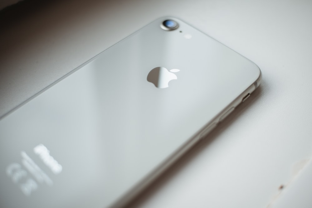 silver iphone 6 on white table