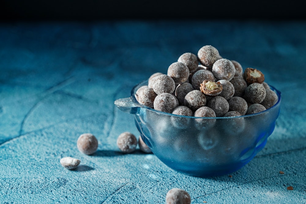 blue and white ceramic bowl with stones