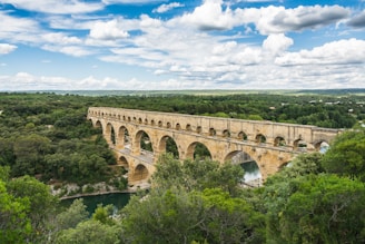 An ancient Roman aqueduct standing tall against the sky.