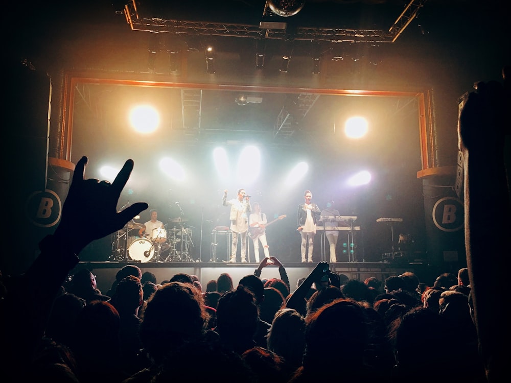 people watching band performing on stage