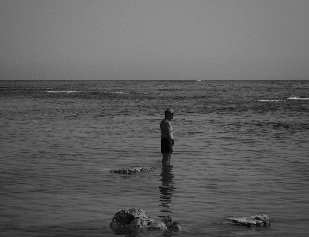 grayscale photo of man in water