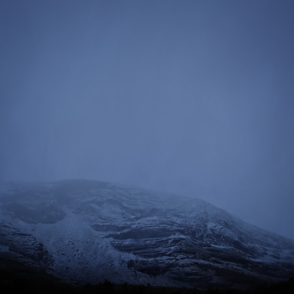 black and white mountain under blue sky