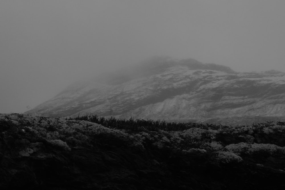 grayscale photo of mountains and clouds