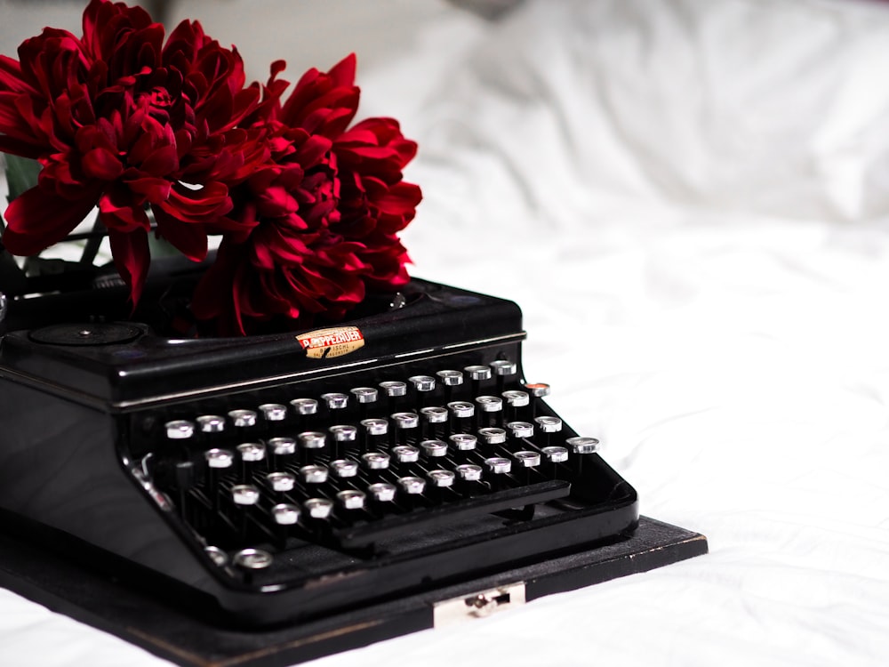 red flower on black typewriter