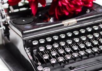 red rose on black typewriter
