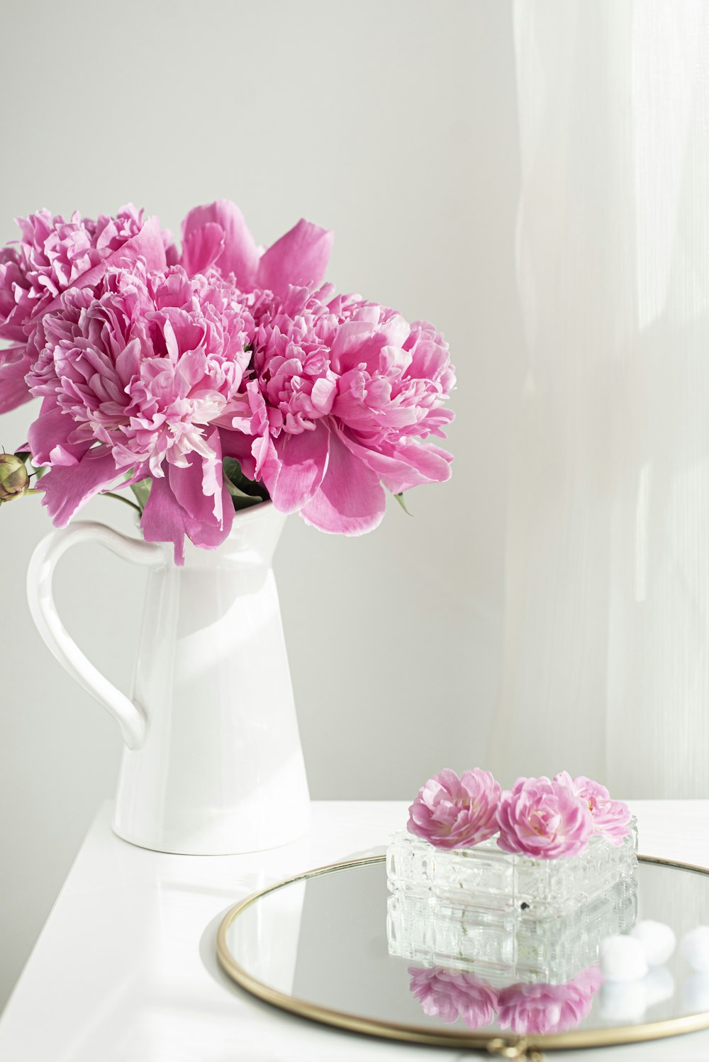 pink flowers in white ceramic vase