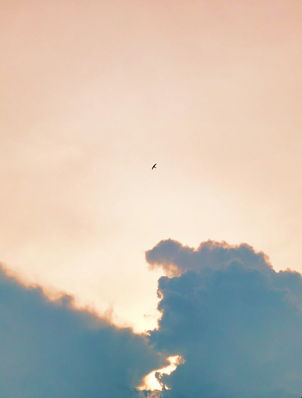 airplane flying over white clouds during daytime