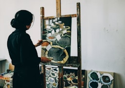 woman in black shirt standing in front of mirror
