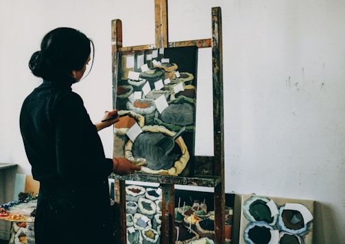 woman in black shirt standing in front of mirror