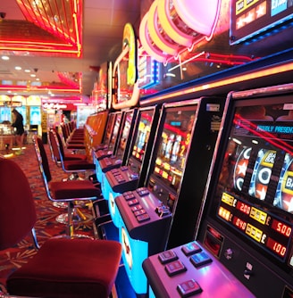 arcade machine with red and white chairs