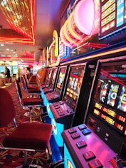 arcade machine with red and white chairs