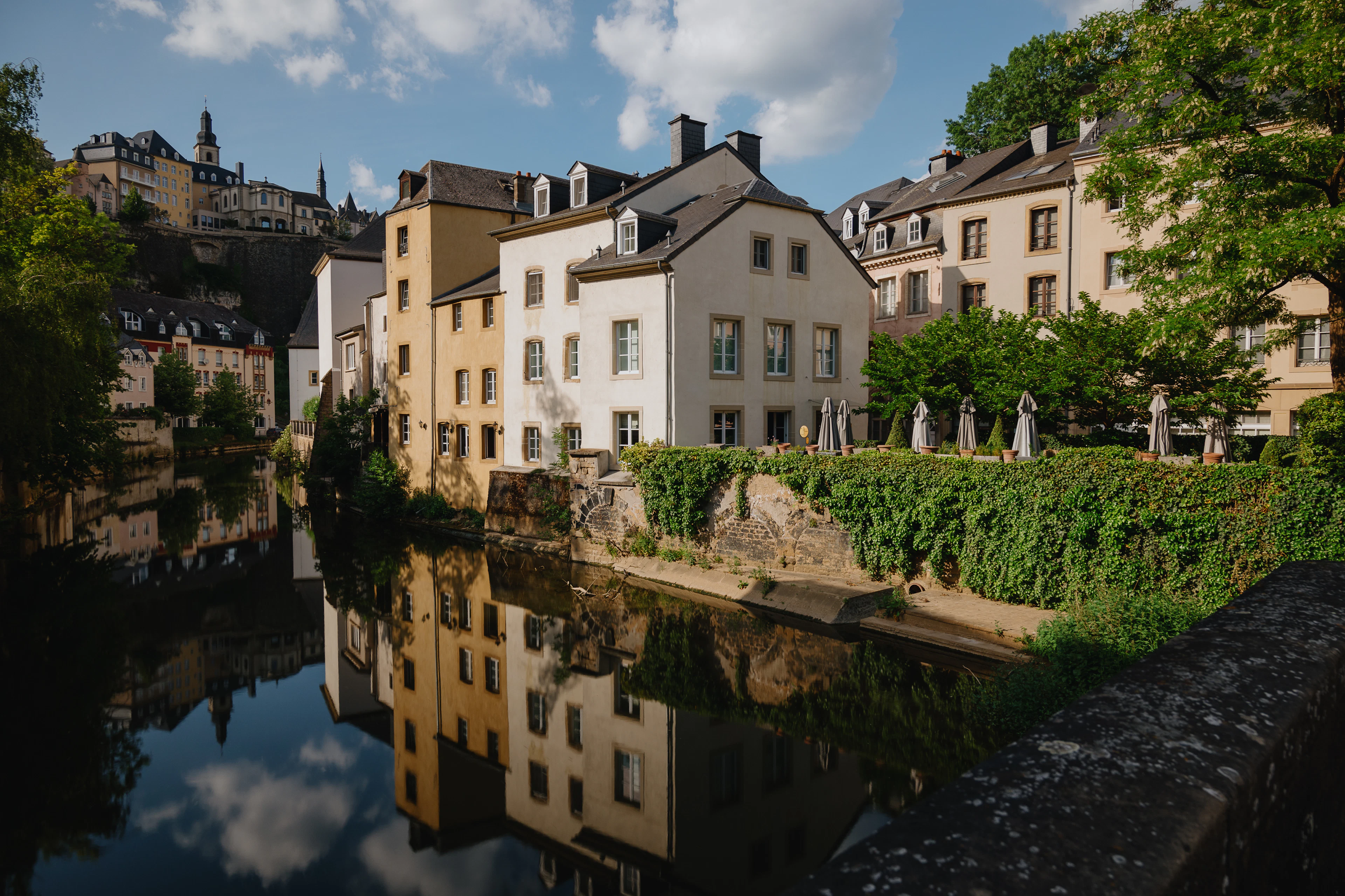 The Alzette running through the Grund in Luxembourg City, old houses reflected in the water