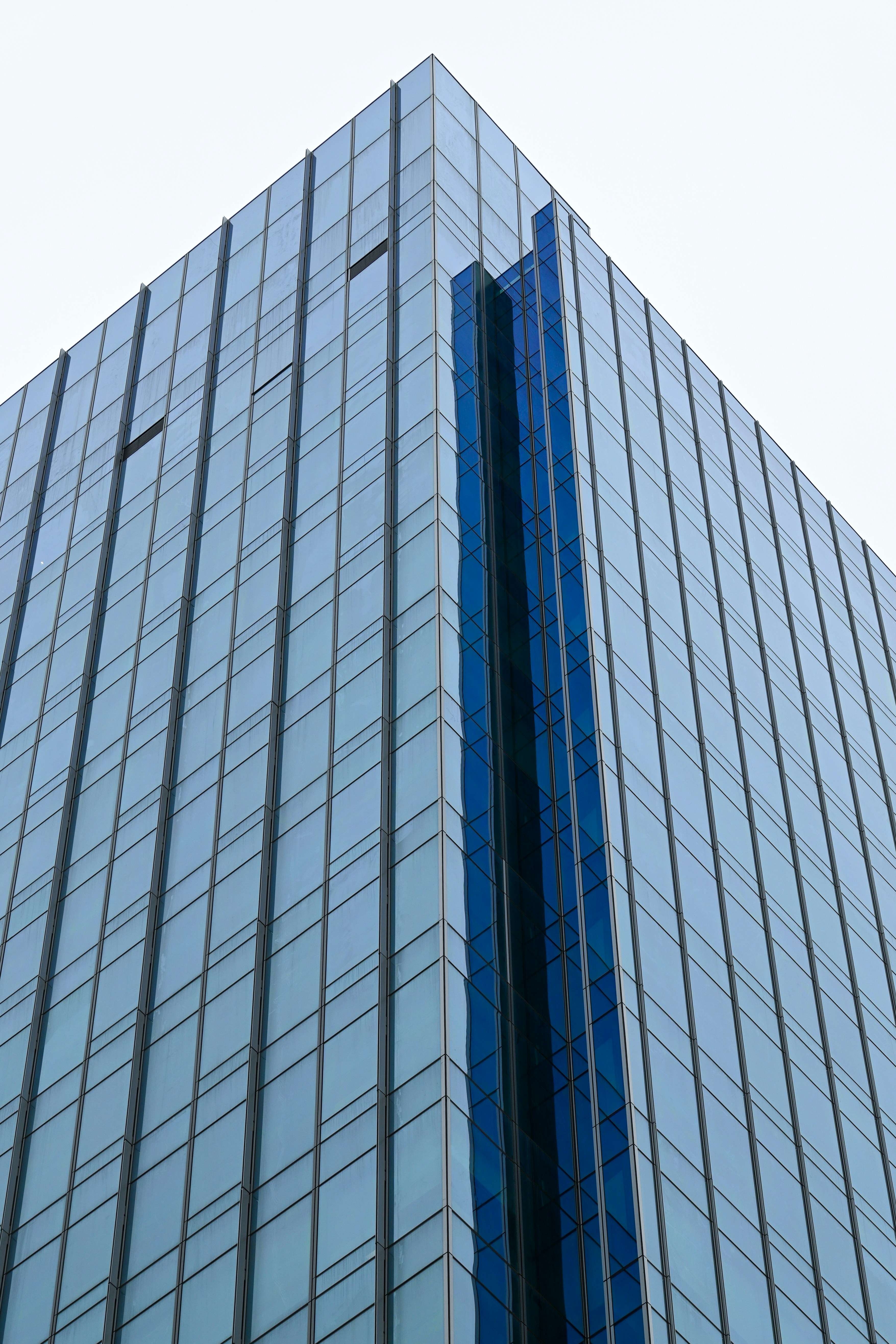 Meridian Tower glass skyscraper reflecting blue sky, modern commercial architecture