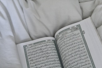 A boy practicing Quran reading with clear Tajweed on screen.