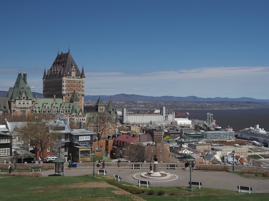 brown and white concrete building near green grass field during daytime in La Citadelle de Québec Canada