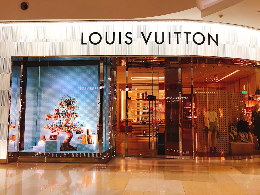 people sitting on bench inside building, Louis Vuitton | Shopping Mall | Orchard Road | Shop Front | Visual Merchandisin