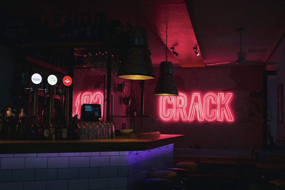 a bar with a neon sign that says crack
