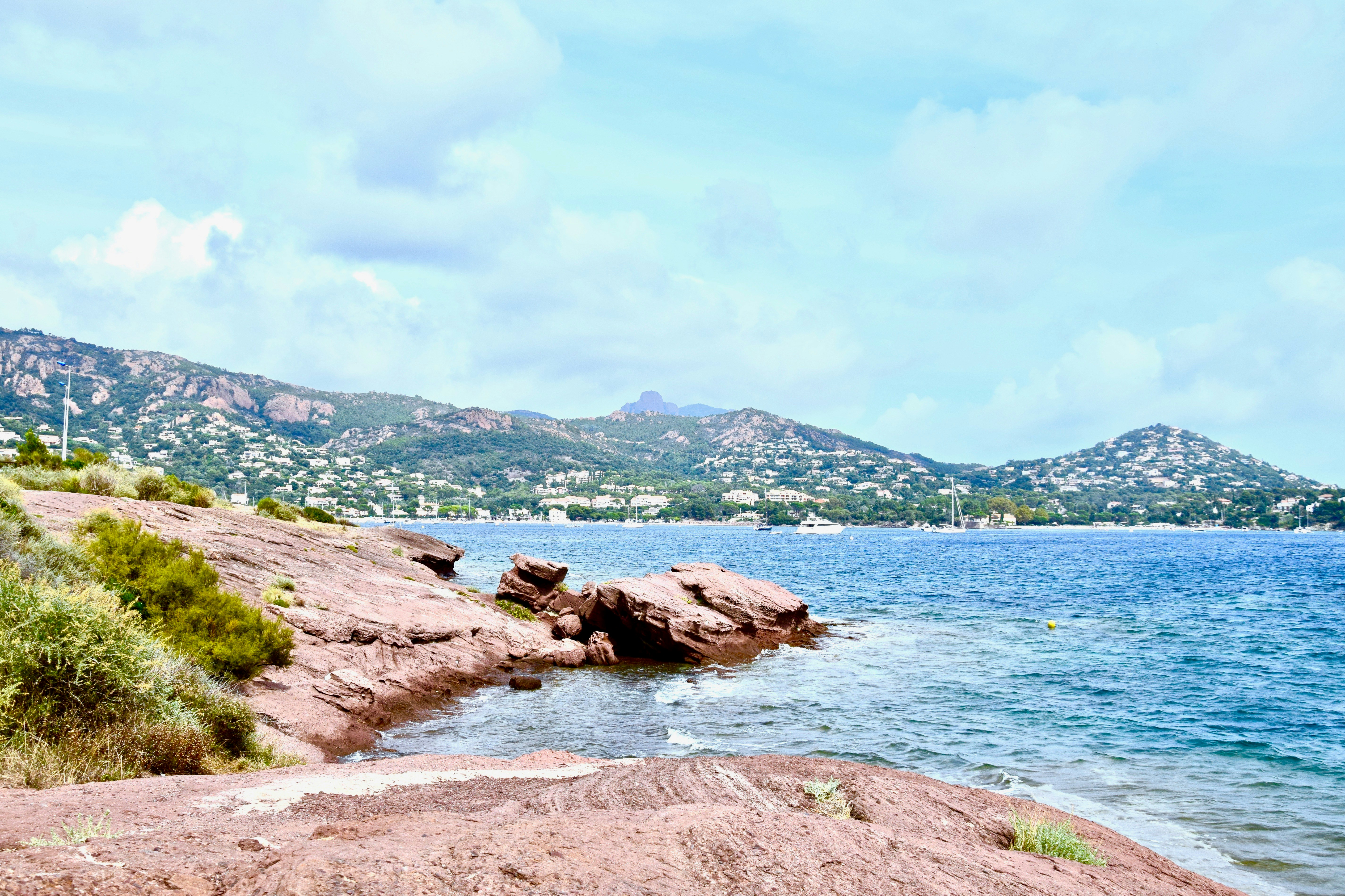 brown rock formation on body of water during daytime, 