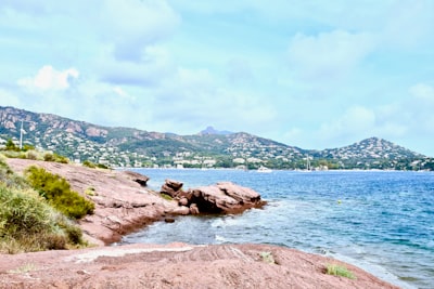 brown rock formation on body of water during daytime nice teams background