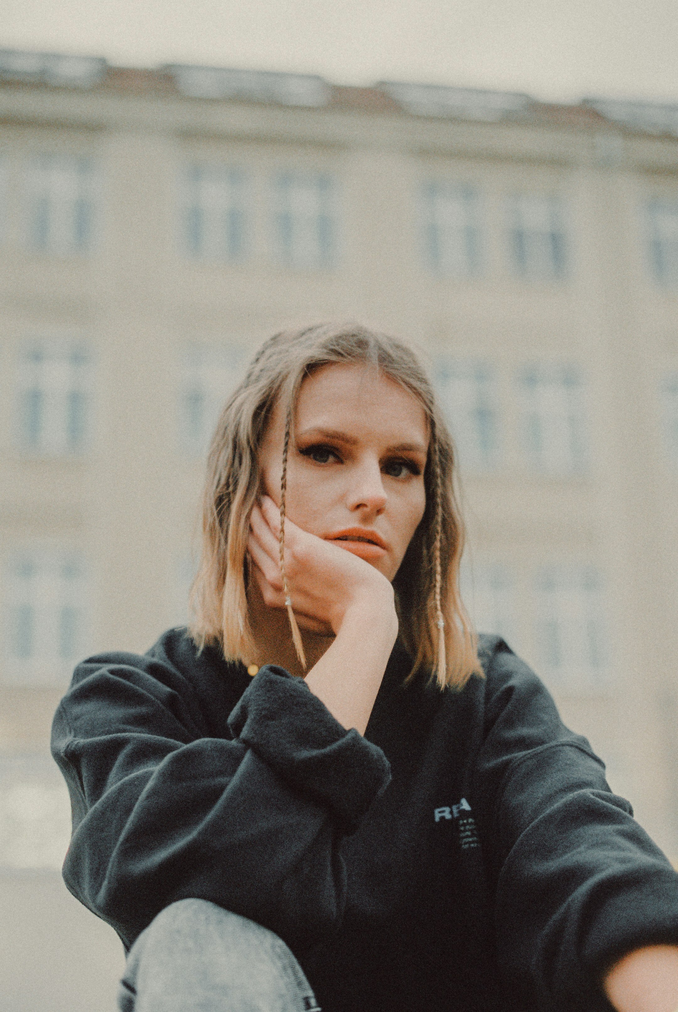 woman in black hoodie with white earbuds