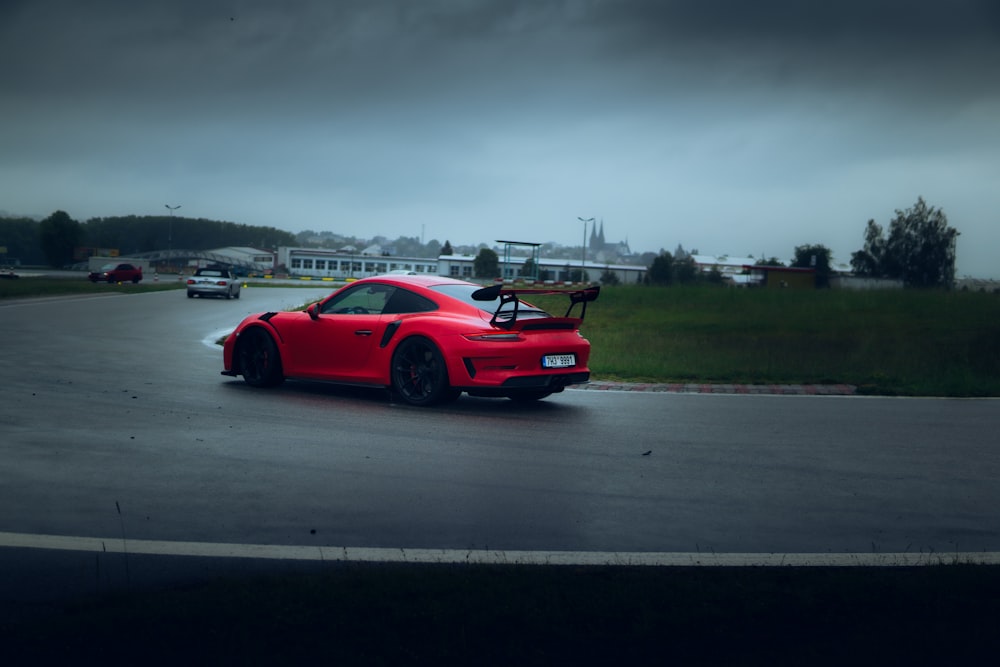 red ferrari 458 italia on road during daytime