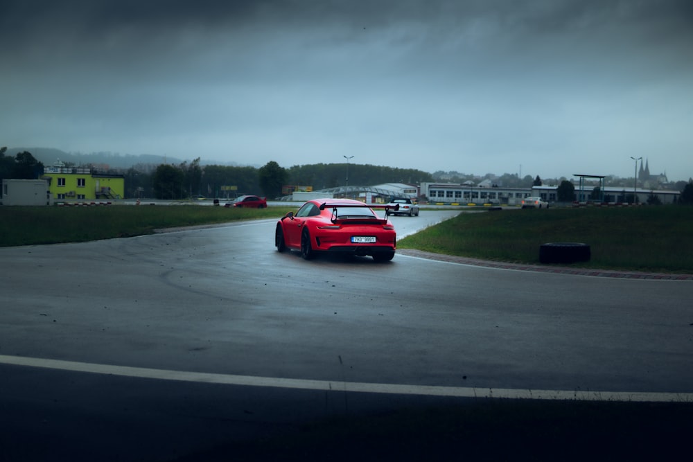 red car on road during daytime