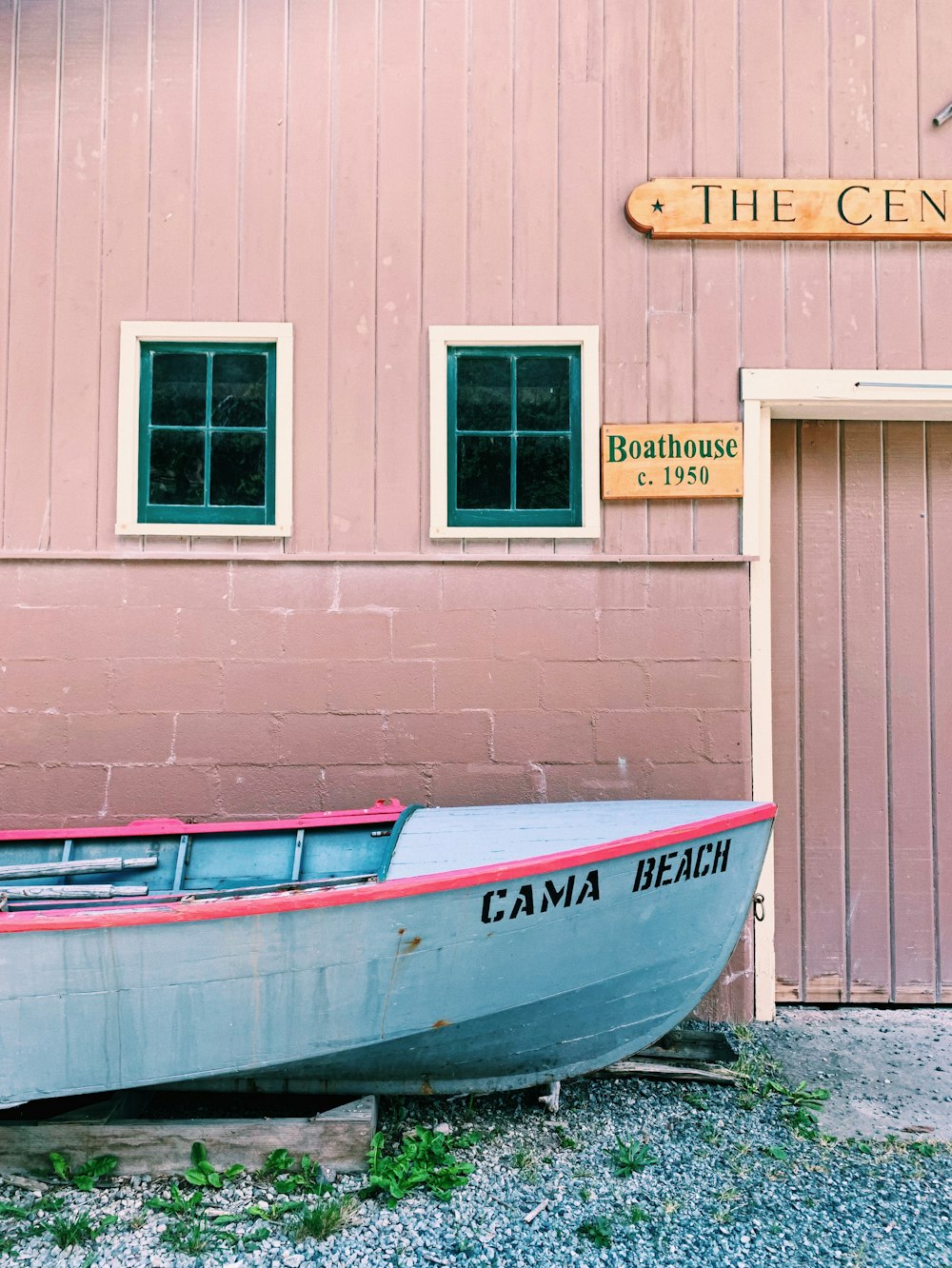 white and blue boat on brown wooden dock during daytime