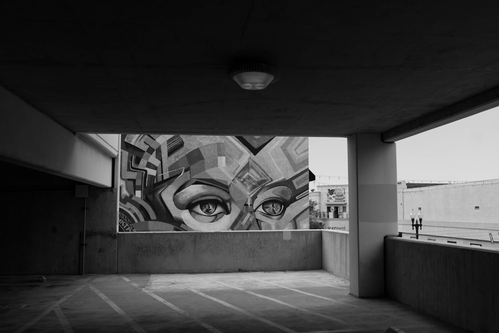 grayscale photo of a wall with graffiti
