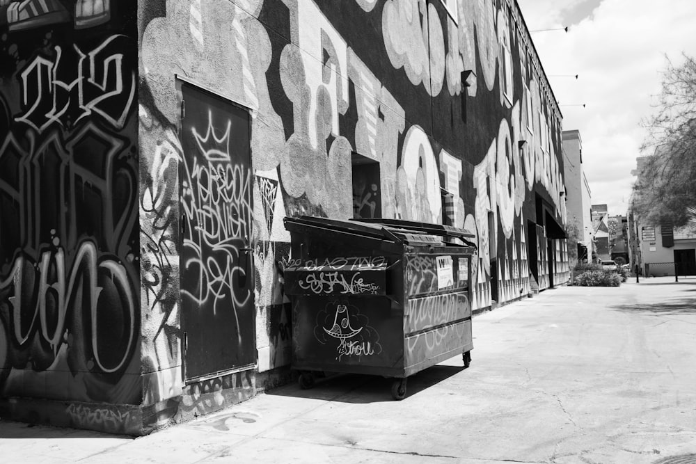 grayscale photo of graffiti on wall