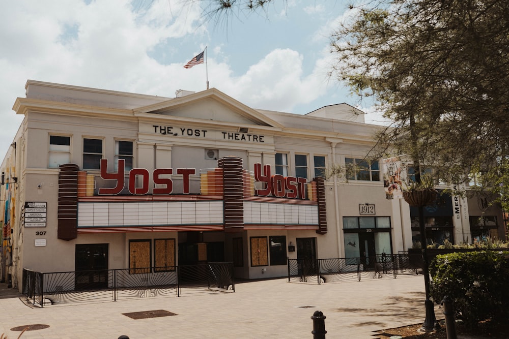 a movie theater with a flag on top of it