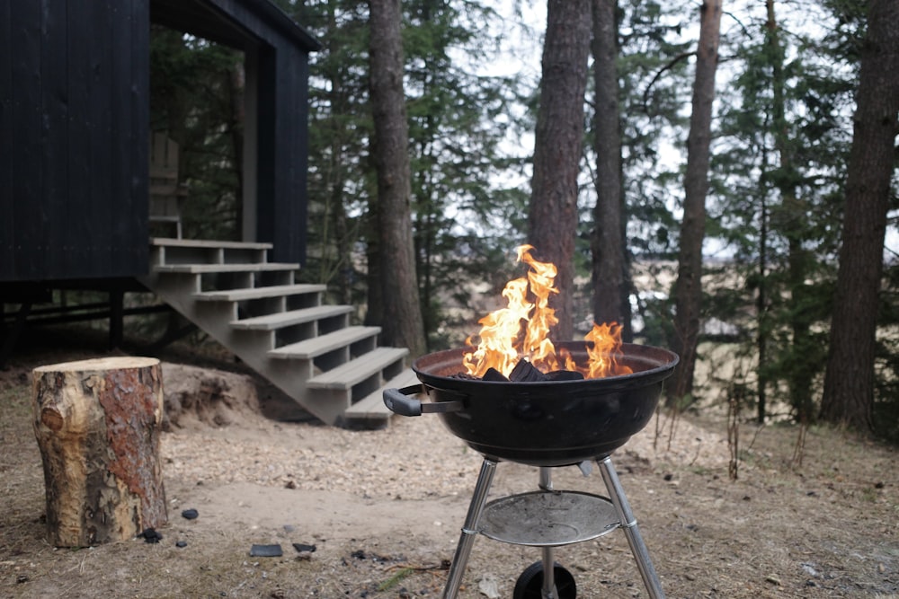 black fire pit on brown sand during daytime