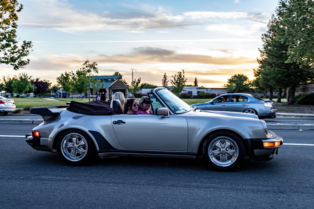 white convertible car on road during daytime