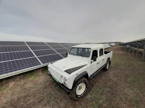 A delivery truck loaded with solar-powered products ready to depart under a sunny sky.