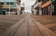 brown wooden pathway between houses during daytime