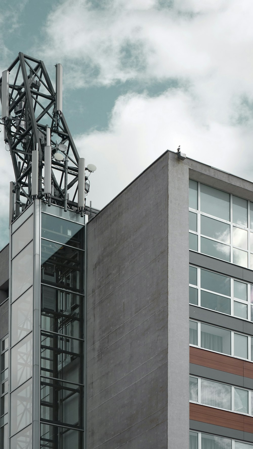 brown concrete building under white clouds during daytime